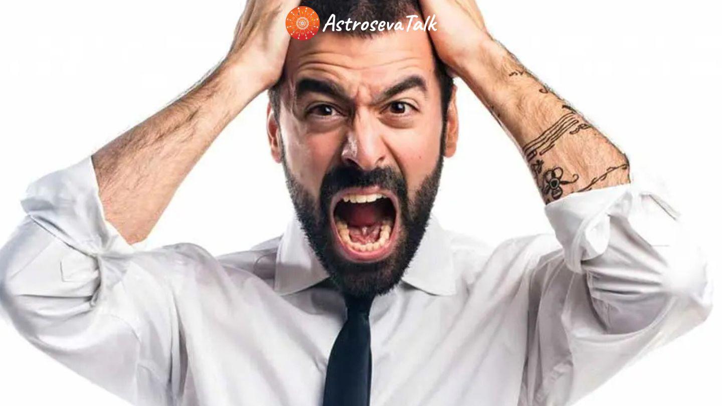 Frustrated man holding head in anger representation of annoying personality traits linked with zodiac signs